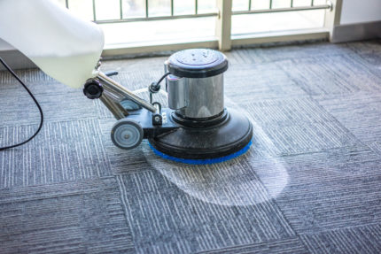 auto scrubber cleaning a commercial carpet in detail
