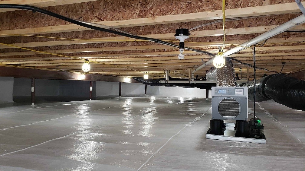 point of view of commercial crawl space with bright lighting and clean hvac